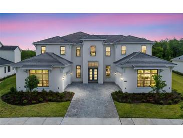 Stunning two-story home featuring a symmetrical facade, attached garages, and professional landscaping at 9847 Laurel Berry Dr, Orlando, FL 32827