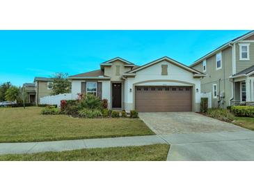 One-story home with brown garage door and landscaped front yard at 2232 Donahue Dr, Ocoee, FL 34761