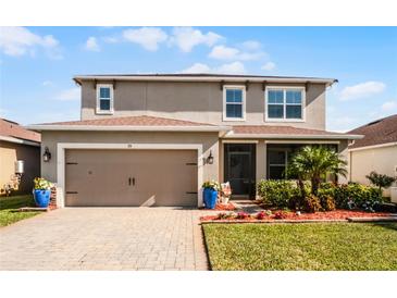 Two-story house with a two-car garage and landscaped front yard at 351 Lazio Cir, Debary, FL 32713