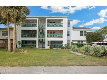 Two-story building with green accents and balconies. Lush landscaping surrounds the building at 488 W Par St # 4, Orlando, FL 32804