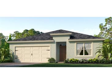One-story home with light-colored siding, a two-car garage, and landscaping at 5068 Tana Ter, St Cloud, FL 34772