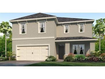 Two-story house with a neutral color scheme and a two-car garage at 5080 Tana Ter, St Cloud, FL 34772