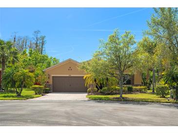 Charming single-story home featuring a well-maintained lawn and attached two-car garage at 800 Ebb Tide Ln, Kissimmee, FL 34759