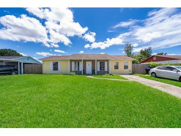 Ranch-style home with a spacious lawn and driveway at 6655 Durango Ct, Orlando, FL 32809