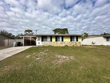 Ranch-style home with stone accents and carport at 21 W Thrush St, Apopka, FL 32712