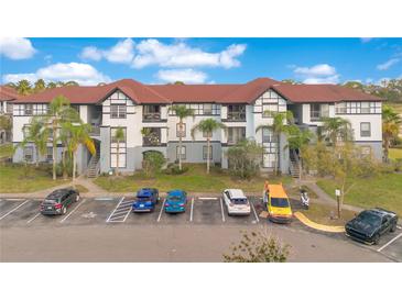 Aerial view of apartment community with ample parking and a pond at 3714 Palm Desert Ln # 5317, Orlando, FL 32839