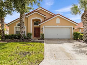 Attractive single-story home with a two-car garage and landscaping at 164 Sevilla Ave, Davenport, FL 33897