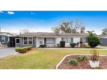 Ranch-style home with gray accents, well-manicured lawn, and mature trees at 2911 Dudley Dr, Bartow, FL 33830
