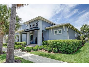 Curb appeal abounds in this beautiful 2-story home, featuring a landscaped yard and inviting front porch at 7901 Dausset St, Orlando, FL 32827