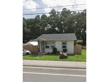 Single-story home with a well-maintained lawn and wood fence at 1968 Berkley Rd, Auburndale, FL 33823