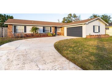 Brick ranch house with attached garage and landscaped lawn at 2855 Cady Way, Winter Park, FL 32792