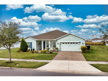 Charming single-story home featuring a well-manicured lawn, neutral exterior paint, and a two-car garage with driveway at 306 Quarry Rock Cir, Kissimmee, FL 34758