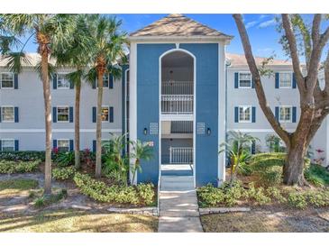 Condo building exterior with blue accents and landscaping at 4208 Clubside Dr # 4208, Longwood, FL 32779