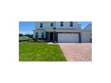 Charming two-story home with a well-manicured lawn at 5067 Northern Dove Ave, Mount Dora, FL 32757