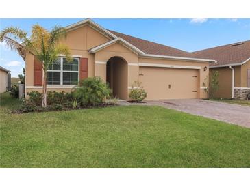 Attractive single-story home with a two-car garage and well-manicured lawn at 603 Lazio Cir, Debary, FL 32713