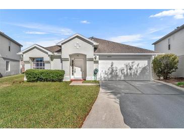 One-story house with a two-car garage and well-maintained lawn at 10828 Cherry Oak Cir, Orlando, FL 32817