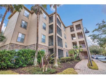 Exterior of a three-story residential building with landscaping and a walkway at 1361 Tuscan Ter # 7401, Davenport, FL 33896