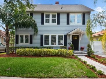 Two-story gray house with black shutters, landscaped yard, and a walkway at 1375 Suffolk Rd, Winter Park, FL 32789