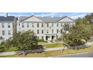 Three story building with classic architecture, manicured lawn, and ample parking at 264 Celebration Blvd # 264, Celebration, FL 34747