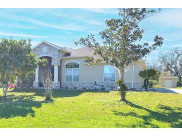 One-story home with stone accents and a spacious lawn at 3330 Earle Ct, Kissimmee, FL 34746