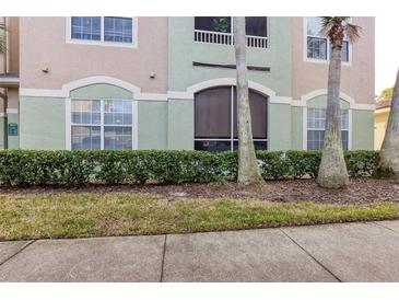 Building exterior with landscaping and palm trees at 4833 Cypress Woods Dr # 4101, Orlando, FL 32811