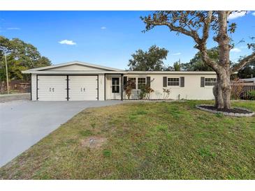 Updated single story home with a two-car garage and well-manicured lawn at 105 Clyde Ave, Longwood, FL 32750