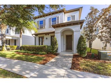 Two-story home with a charming front porch and landscaped yard at 11560 Ashlin Park Blvd, Windermere, FL 34786