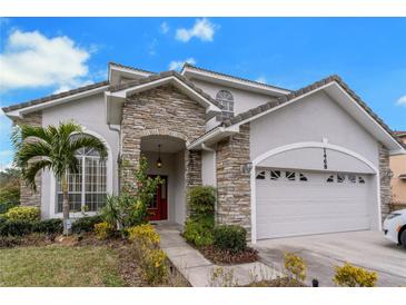 Two-story house with stone accents and a two-car garage at 1468 Patricia St, Kissimmee, FL 34744