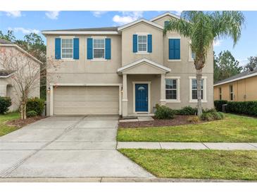 Two-story house with blue accents and a two-car garage at 3464 Julius Estates Blvd, Winter Haven, FL 33881