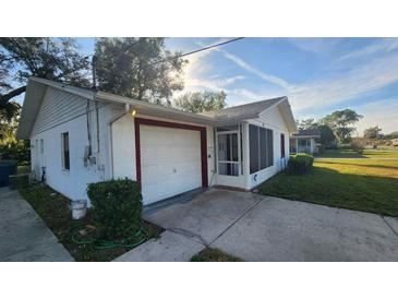 White single-story house with a garage and screened porch at 436 Avenue G Se, Winter Haven, FL 33880