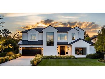Stunning two-story home with a modern design, landscaped lawn, and a three-car garage at 1830 Park Lake St, Orlando, FL 32803