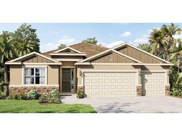 Two-story house with a three-car garage and stone accents at 3215 Arch Ave, Ormond Beach, FL 32174