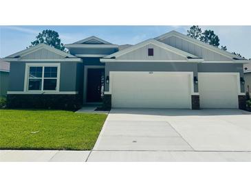 Charming single-Gathering home with a two-car garage, beautiful landscaping, and a well-maintained lawn at 3221 Arch Ave, Ormond Beach, FL 32174