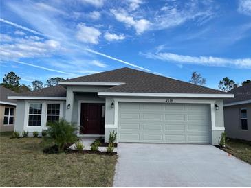 Single-story house with a two-car garage and front landscaping at 4312 Sagefield Drive, St Cloud, FL 34773