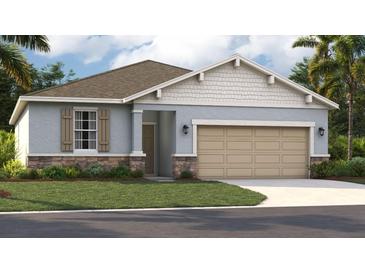 One-story home with light gray siding, stone accents, and a two-car garage at 1694 Blue Lagoon Cir, Mascotte, FL 34753