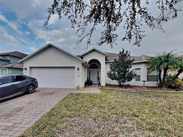 Single-story house with attached garage and landscaped lawn at 2739 Star Grass Cir, Kissimmee, FL 34746