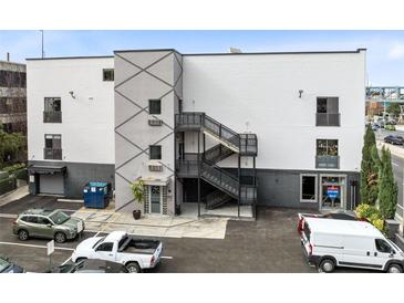 Modern building exterior with parking and multiple entrances at 62 W Colonial Dr # 205, Orlando, FL 32801