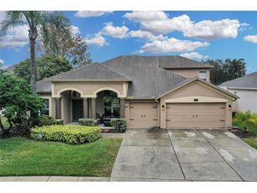 Two-story house with a large driveway and landscaped front yard at 11013 Creighton Dr, Orlando, FL 32817