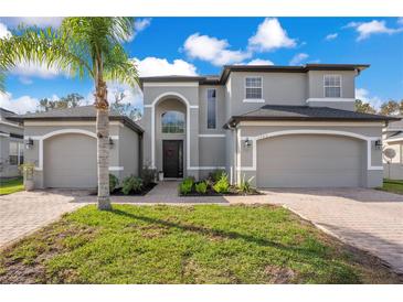 Two story house with gray siding, three car garage, and landscaping at 1763 Stargazer Ter, Sanford, FL 32771