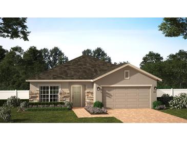 One-story home with stone accents, two-car garage, and landscaped front yard at 27469 Black Kite Ave, Howey In The Hills, FL 34737