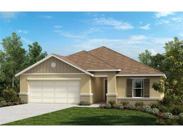 One-story home with two-car garage, landscaped lawn, and neutral color palette at 5571 Creek Haven Way, Lakeland, FL 33810