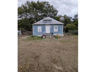 Fixer-upper home with a rustic exterior and needs significant renovations at 620 Cochran Rd, Geneva, FL 32732