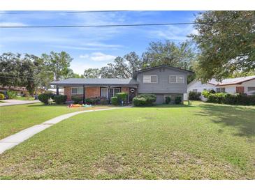 Ranch style home with brick facade and spacious lawn at 680 Avenue N Se, Winter Haven, FL 33880