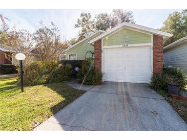 Brick home with attached garage and landscaped yard at 3934 Ne 21St Ln, Ocala, FL 34470