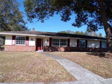 Brick ranch house with red shutters, and walkway at 4131 Yorketowne Rd, Orlando, FL 32812