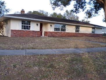 Ranch style home with brick facade and large windows at 4131 Yorketowne Rd, Orlando, FL 32812