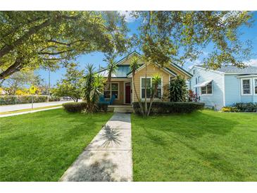 Charming bungalow with green metal roof, landscaping, and walkway at 436 E Jersey St, Orlando, FL 32806