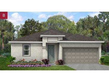 One-story home with gray siding, two-car garage, and landscaped front yard at 507 Silver Palm Dr, Haines City, FL 33844