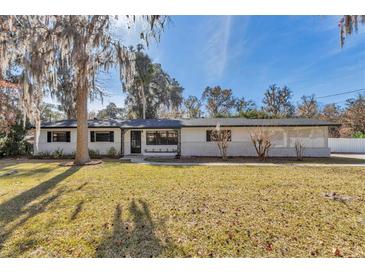 Charming ranch home with white brick facade and spacious lawn at 520 Sw 38Th St, Ocala, FL 34471