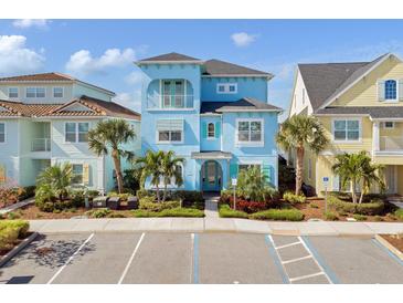 Two-story light blue house with a walkway, landscaping, and palm trees at 8153 Surf St, Kissimmee, FL 34747